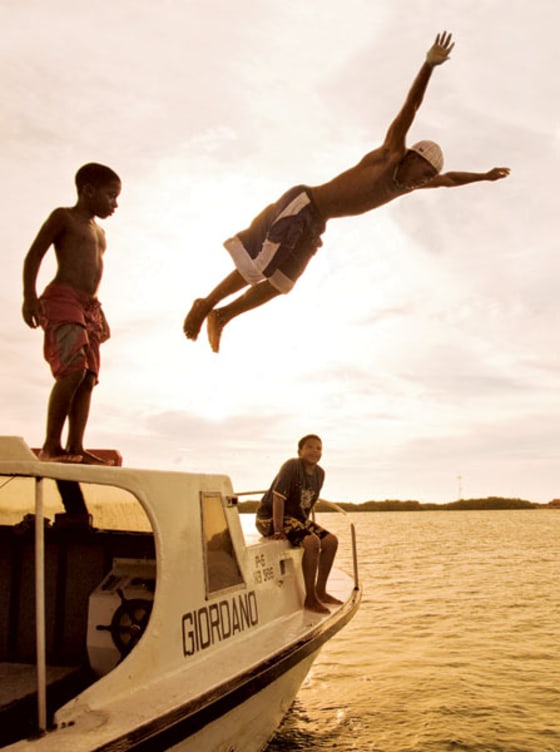 Free-falling into the clear waters off Lac Bay.